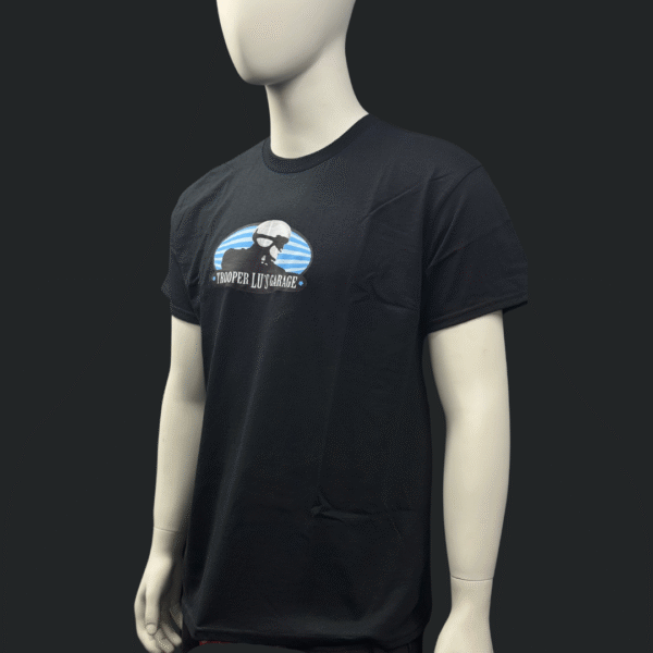 A mannequin wears the TROOPER LU T-SHIRT - MEN'S, displaying a bold graphic of a bearded man in sunglasses with "TROOPER LUISVALDEZ" across the chest.