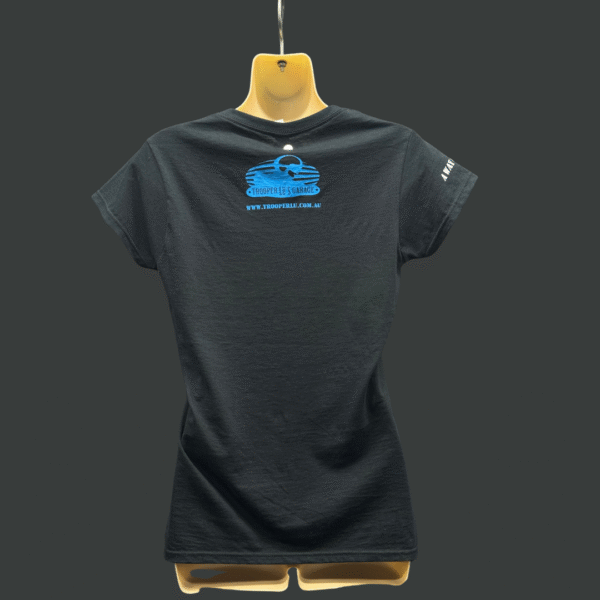 The TROOPER LU T-SHIRT - WOMEN'S is a black short-sleeve shirt displayed on a mannequin, featuring a blue logo and website text on the back, plus white text on the left sleeve.
