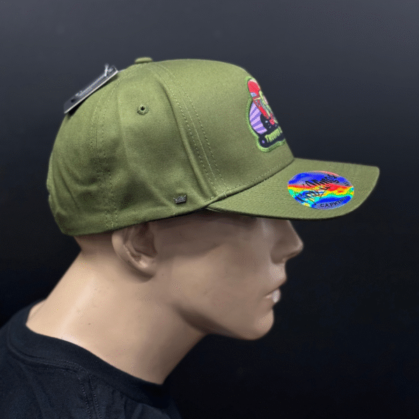 A mannequin head wears TLG's UFLEX PRO STYLE SNAPBACK CAP GREEN featuring a colorful front patch and a holographic brim sticker, set against a black background.