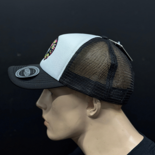 A side view of a mannequin head wearing TLG's UFLEX SNAP BACK TRUCKER CAP BLACK/WHITE MESH with a circular patch on the front and a sticker on the brim.