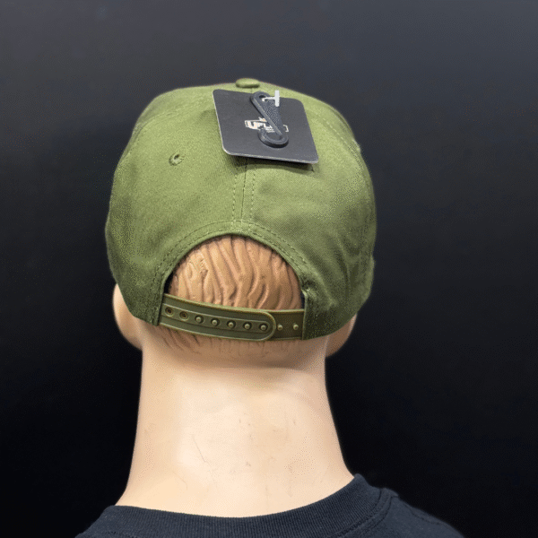 A mannequin head is facing away, wearing TLG's UFLEX PRO STYLE SNAPBACK CAP in green, featuring an adjustable strap and a black tag on top.