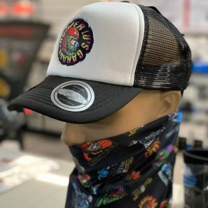 Mannequin wearing TLG's UFLEX Snap Back Trucker Cap in black and white mesh with a colorful patch, paired with a black bandana showcasing vibrant designs.