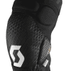 A black knee pad with a textured design and a prominent white logo on the front.