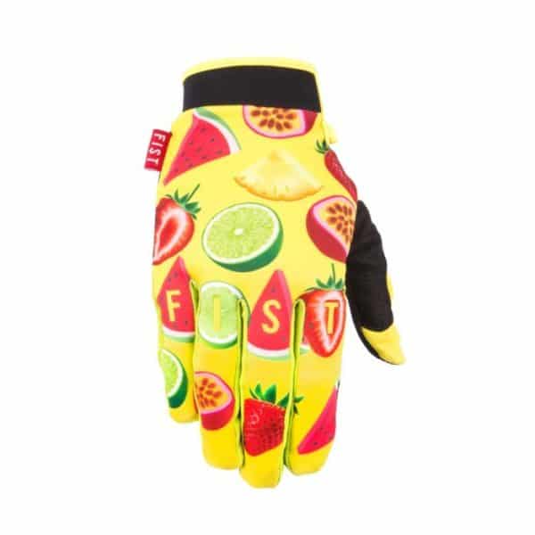 The FIST Caroline Buchanan Smoothie Gloves feature a vibrant fruit design with strawberries, watermelons, and limes on a yellow background, complemented by a contrasting black palm and a bold red "FIST" tag on the wrist.