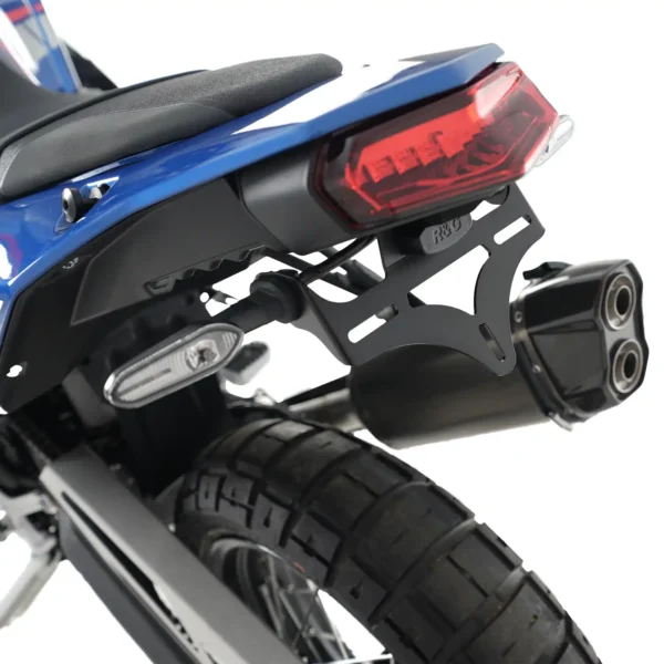 Rear view of a Yamaha 19-24 Tenere 700 features the R&G Tail Tidy, highlighting a red taillight, exhaust pipes, and a treaded tire.