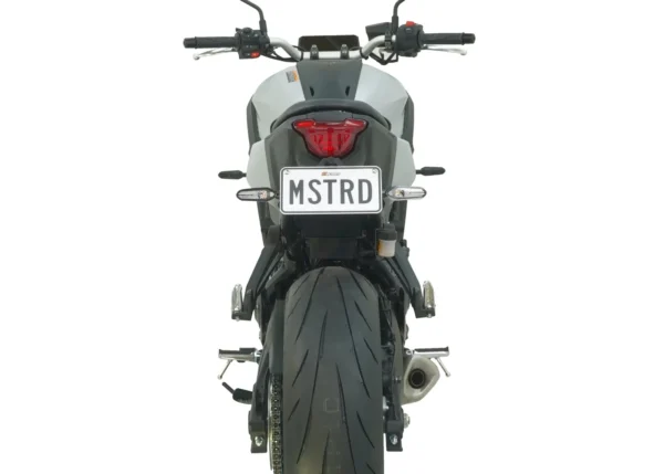 A MUSTARD MT-07 2025 TAIL TIDY - 186MM motorcycle is shown from the rear with the "MSTRD" license plate, highlighting its prominent rear tire, dual exhaust pipes, and compact tail light against a white background.
