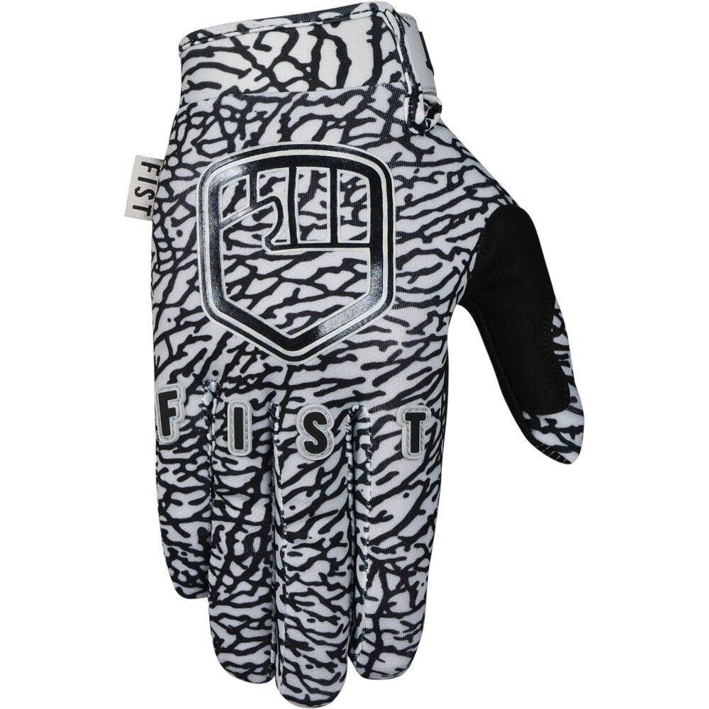The FIST ELEPHANT GLOVES - KIDS are black and white patterned gloves featuring "FIST" and a shield logo printed on the back.