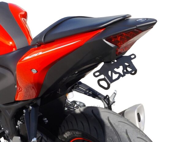 Close-up of the YZF-R3 2019 ONWARDS MUSTARD TAIL TIDY - 186mm in red and black, highlighting the seat, taillight, rear tire, and license plate holder against a white background.