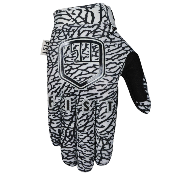 A single FIST ELEPHANT GLOVE - LIL FISTS (AGES 2-8), black and white with a textured abstract pattern, "FIST" lettering, and a shield-inspired logo on the back.