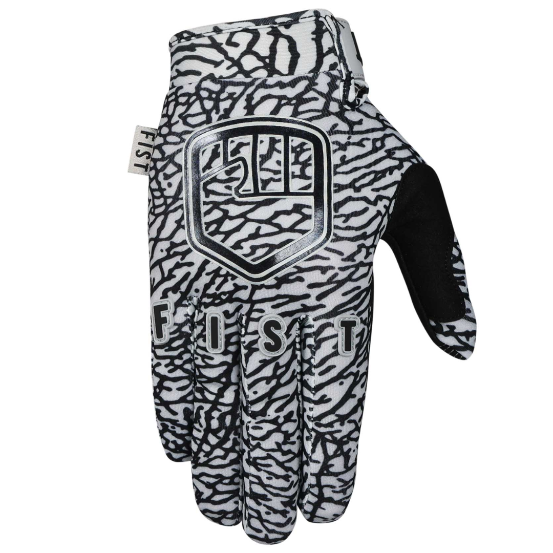 A single FIST ELEPHANT GLOVE - LIL FISTS (AGES 2-8), black and white with a textured abstract pattern, "FIST" lettering, and a shield-inspired logo on the back.